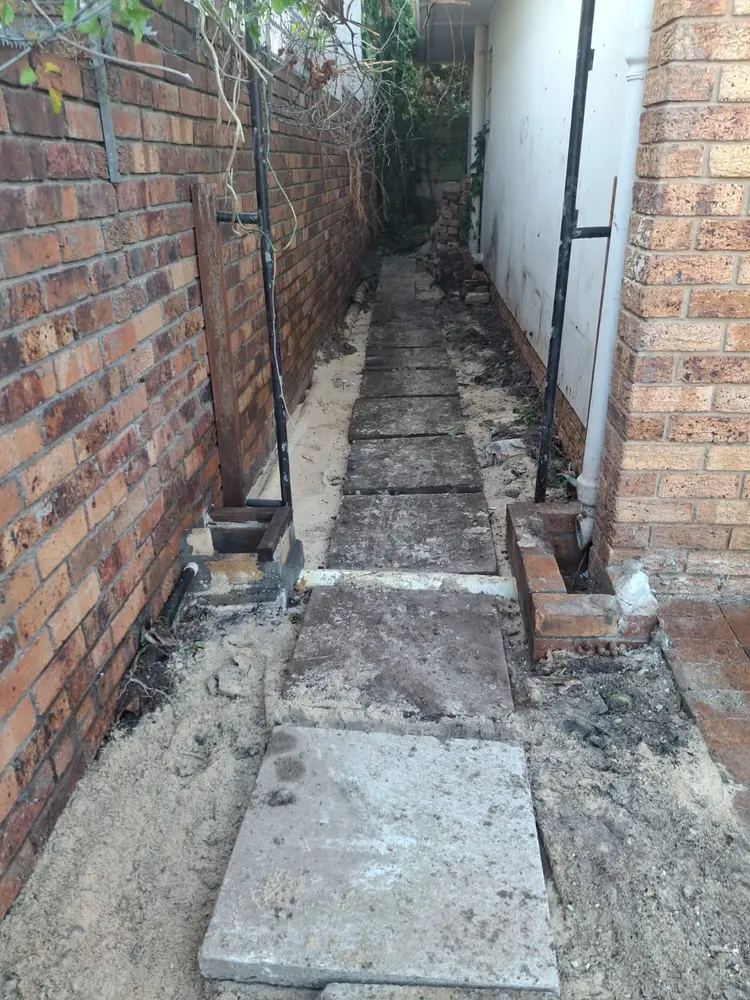 Side passage backfilled and paving relaid after a drain replacement