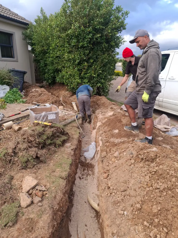 Vic's Plumbing crew excavating a trench to replace an underground supply line